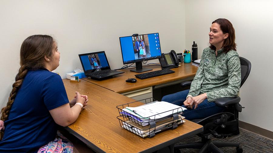 Advisor meeting with a student in an office